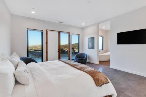 a bedroom with a large bed and a flat screen tv at Casa Nicole in Yucca Valley