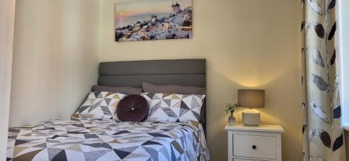 a bedroom with a bed and a picture on the wall at The West Wick House in Weston-super-Mare