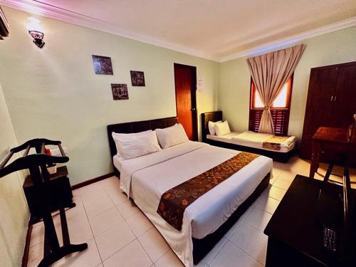 um quarto de hotel com uma cama grande e uma janela em MORTEN VILLA MELAKA em Malaca
