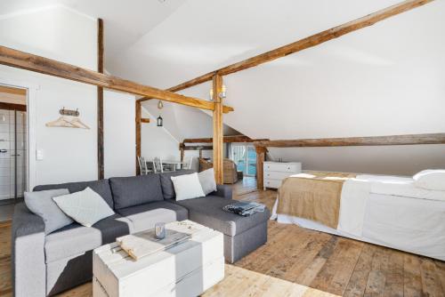 a living room with a couch and a bed at Sveggvika Guesthouse in Averoy