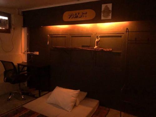 a dark room with a bed and a bar in it at Casa Ausa - Bacnotan La Union in Bacnotan