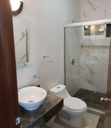 a bathroom with a toilet and a sink at Milan cuatro. 2 cuadras de Playa del delfin in Mazatlán