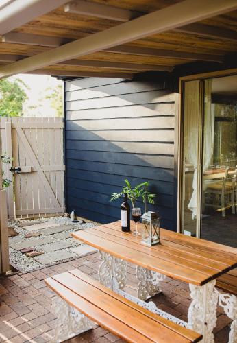 a wooden table sitting on a patio at Forgotten Valley Guesthouse in Gunderman