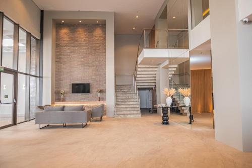a living room with a couch and a fireplace at Dall'Onder Planalto Hotel Bento Gonçalves in Bento Gonçalves