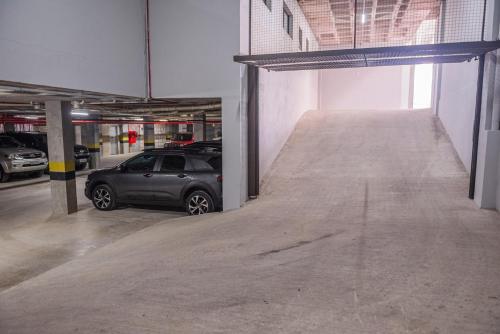 a parking garage with a car parked in it at Dall'Onder Planalto Hotel Bento Gonçalves in Bento Gonçalves