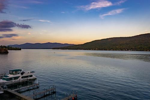 a boat docked at a dock on a lake at The Lake Motel in Lake George