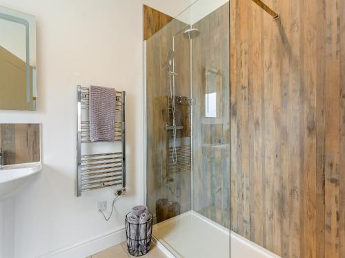 a bathroom with a shower with a glass door at Old School House 