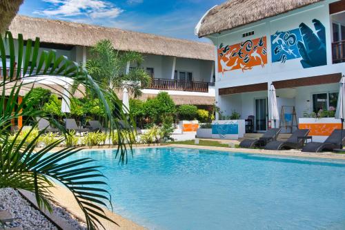 a resort with a swimming pool in front of a building at Amihan Resort in Panglao