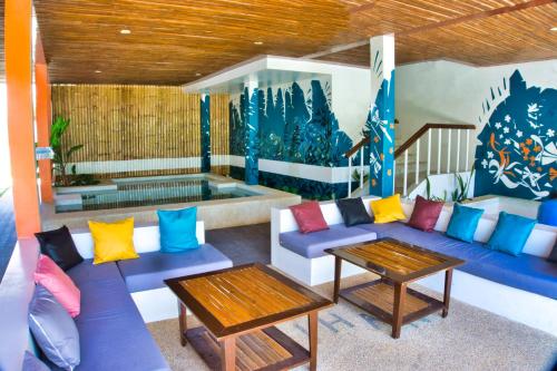 a living room with a blue couch and colorful pillows at Amihan Resort in Panglao