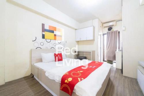 a bedroom with a large bed in a room at Apartemen Kemang View - Room 88 Tower Acasia in Jakarta