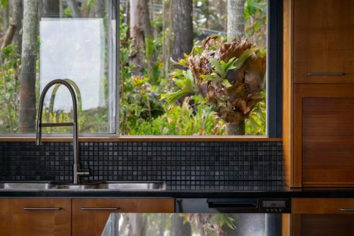 a kitchen counter with a sink and a window at Norm's Place + Waterfront House + Beachfront in Amity Point