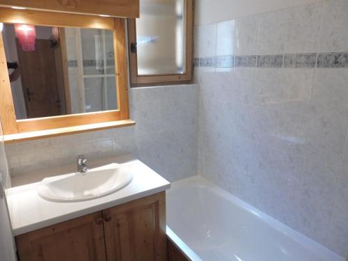 a bathroom with a sink and a bath tub at Appartement Crest-Voland, 3 pièces, 4 personnes - FR-1-595-76 in Crest-Voland
