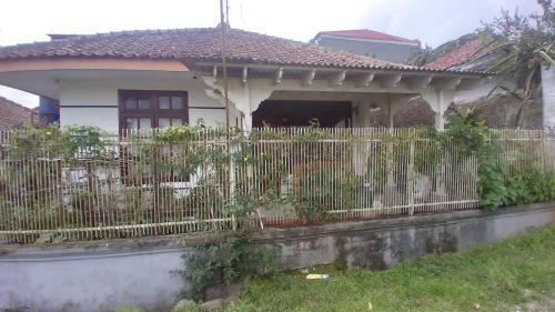 a white fence in front of a house at Villa Galaxy Resort C15 in Cipanas