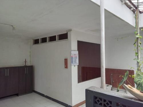 a room with a large white wall with a door at Villa Galaxy Resort C15 in Cipanas