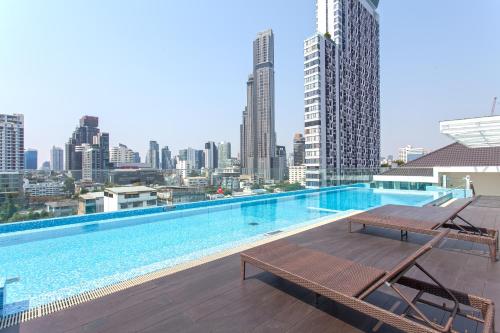 a swimming pool with a view of the city at GM Residence in Bangkok