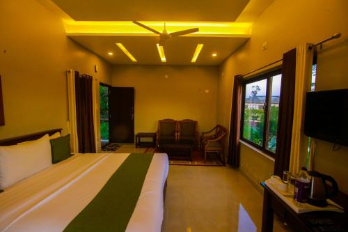 a bedroom with a bed and a tv in a room at CeeCee Grand Resort in Vagamon