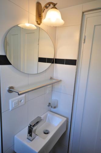 a bathroom with a sink and a mirror at Lake View Chalet in Bönigen