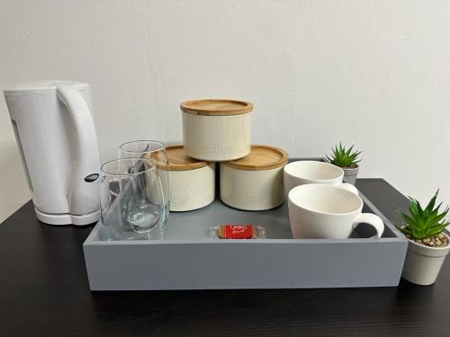 a tray with cups and other items on a table at Premium Studio Flat 04 in Central London in London