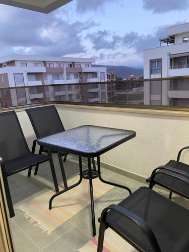 a table and chairs on the roof of a balcony at Ulcinj Apartments in Ulcinj