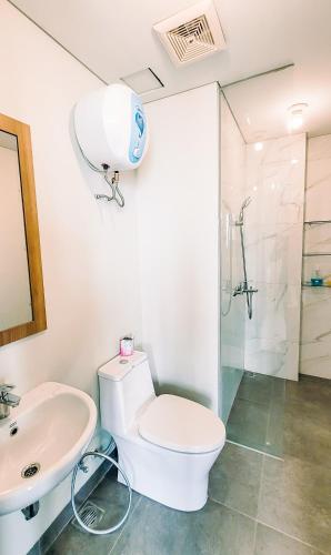 a bathroom with a toilet and a sink and a shower at Palam Mansion at Apartment One Residence in Batam Center