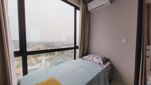 a bed in a room with a large window at Palam Mansion at Apartment One Residence in Batam Center