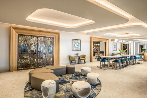 a living room with a couch and a table and chairs at Crowne Plaza Resort Guam in Tumon