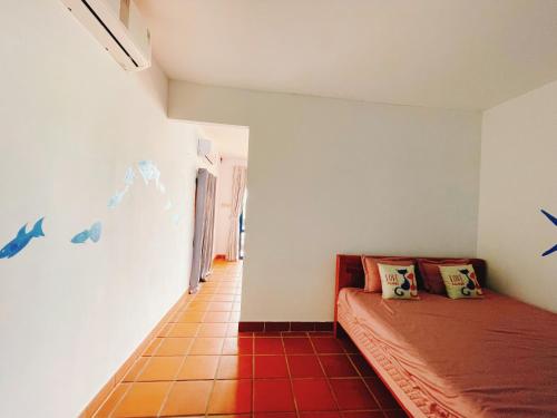 a room with a bed and a wall with birds on it at Bãi Xếp Beach in Quy Nhon