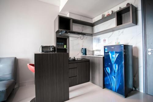 a kitchen with a blue refrigerator in a room at Palam Mansion at Apartment One Residence in Batam Center