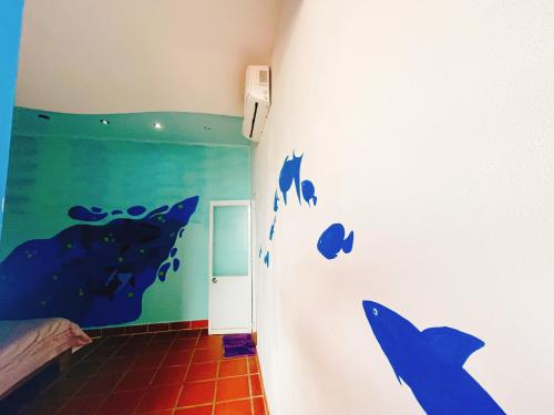 a room with dolphins painted on the wall at Bãi Xếp Beach in Quy Nhon