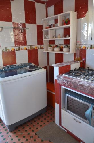 a kitchen with a stove and a stove top oven at chambre priver in Rabat