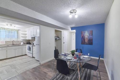 a kitchen and dining room with a table and chairs at 2bedroom suite w/ great access into & out the city - 7818 in Calgary