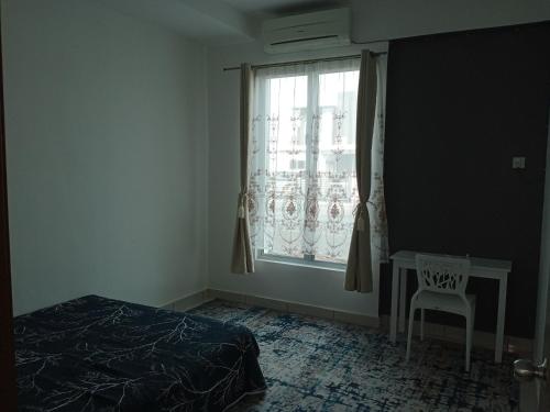 a bedroom with a bed and a window with a chair at MY KIJANG HOMESTAY - Banglo, Alor Setar Kedah DarulAman in Alor Setar