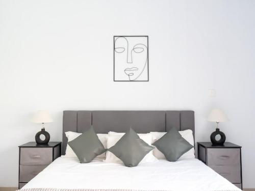 a bedroom with a bed with a picture of a mask at Simco Villa 3 En-suite Bedrooms CANGGU in Canggu