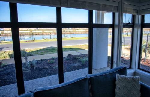 a living room with large windows looking out onto a street at NAUTILUS in Point Lonsdale
