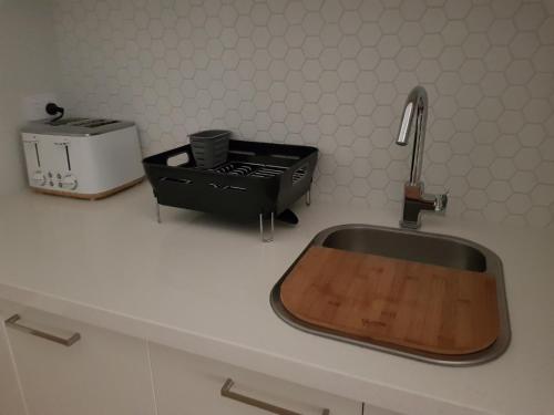 a kitchen counter with a sink and a toaster at NAUTILUS in Point Lonsdale