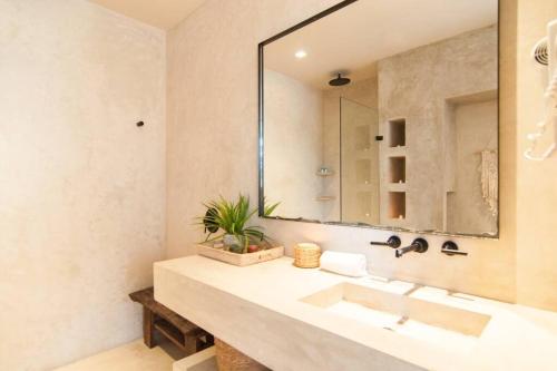 a bathroom with a sink and a large mirror at Spectacular Villa Gaia/PH/private pool in Tulum