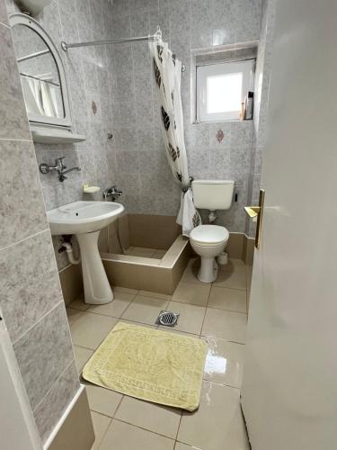 a small bathroom with a sink and a toilet at Apartment Dijana in Petrovac na Moru