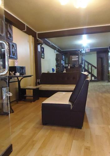 a living room with a couch and a table at Hostal Pablo's House in Machu Picchu