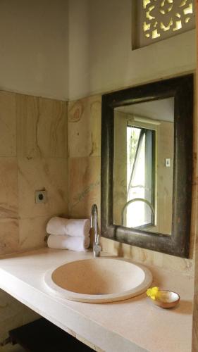a bathroom with a sink and a mirror at VILLA BAMBOO in Silebeng