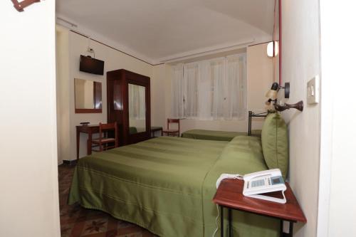 Posteľ alebo postele v izbe v ubytovaní Hotel Villa Amelia