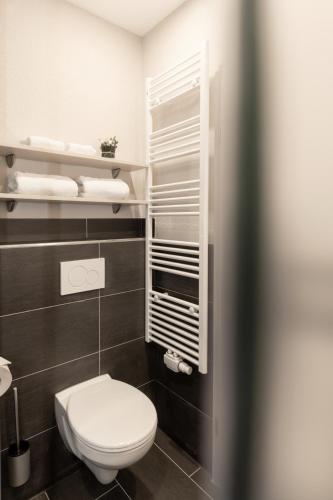 a bathroom with a white toilet and some towels at Das Hohenried in Freudenstadt