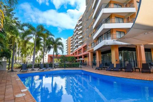 a swimming pool in front of a building at ZEN88 ESPLANADE: 1-BR Top Floor Ocean View Suite in Darwin