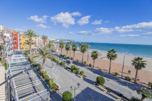 vistas a la playa, a los edificios y a las palmeras en HAPPYVILA Apartments, en Villajoyosa