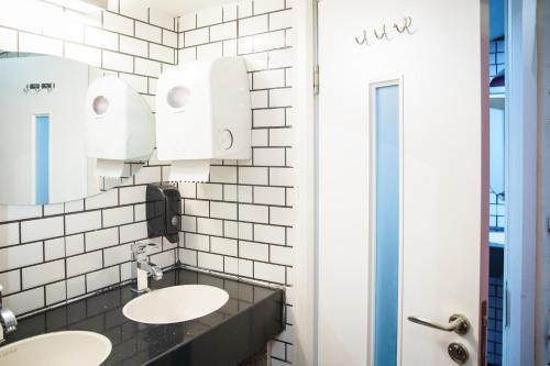 a bathroom with two sinks and a mirror at Cinema Capsules in Jerusalem