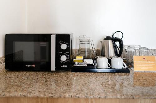 a microwave sitting on top of a counter at Regency Grand Suites in Manila