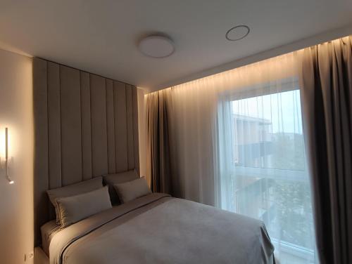 Ένα ή περισσότερα κρεβάτια σε δωμάτιο στο Luxury Vanagupė Apartments & SPA