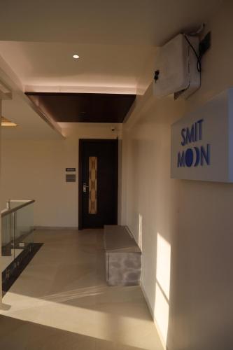a waiting room with a sign on the wall at Blisss Hotel Kolhapur in Kolhapur