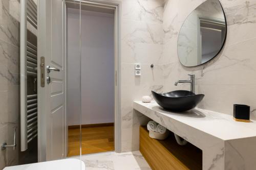 a bathroom with a bowl sink and a mirror at Mirabilia, Unique view meets true elegance in Krotiri