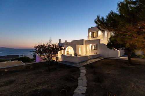 a white house with a view of the ocean at Mirabilia, Unique view meets true elegance in Krotiri