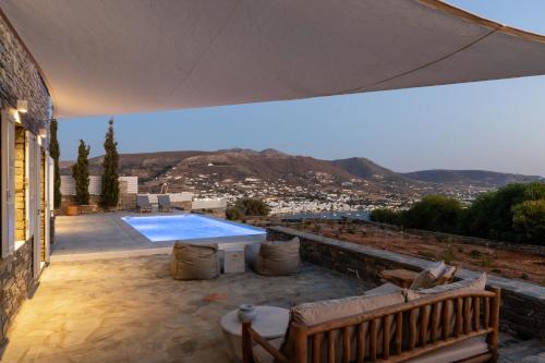 a house with a swimming pool on a patio at Mirabilia, Unique view meets true elegance in Krotiri